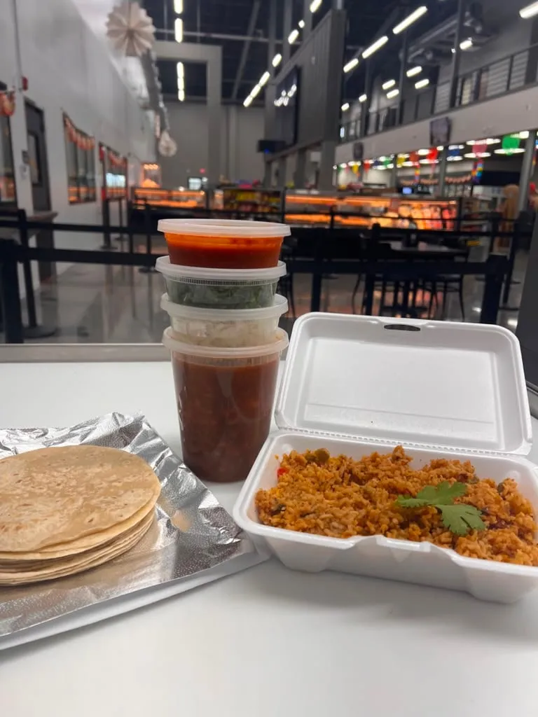 A takeout order: rice, warm tortillas and salsas