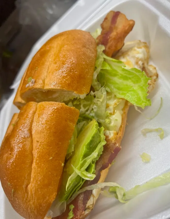 A torta with bacon, egg, avocado and lettuce